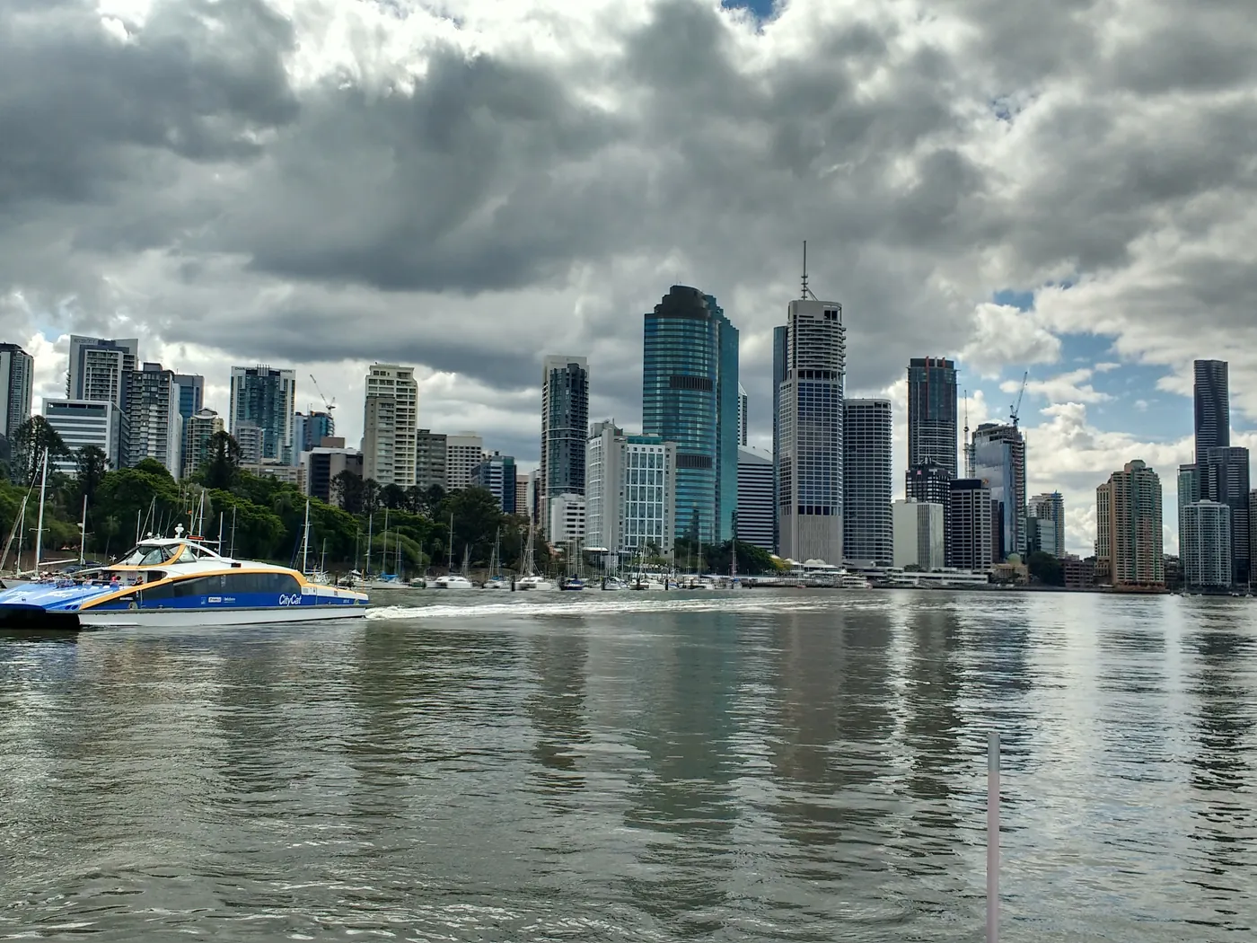 A ferry on the Brisbane River below the city skyline