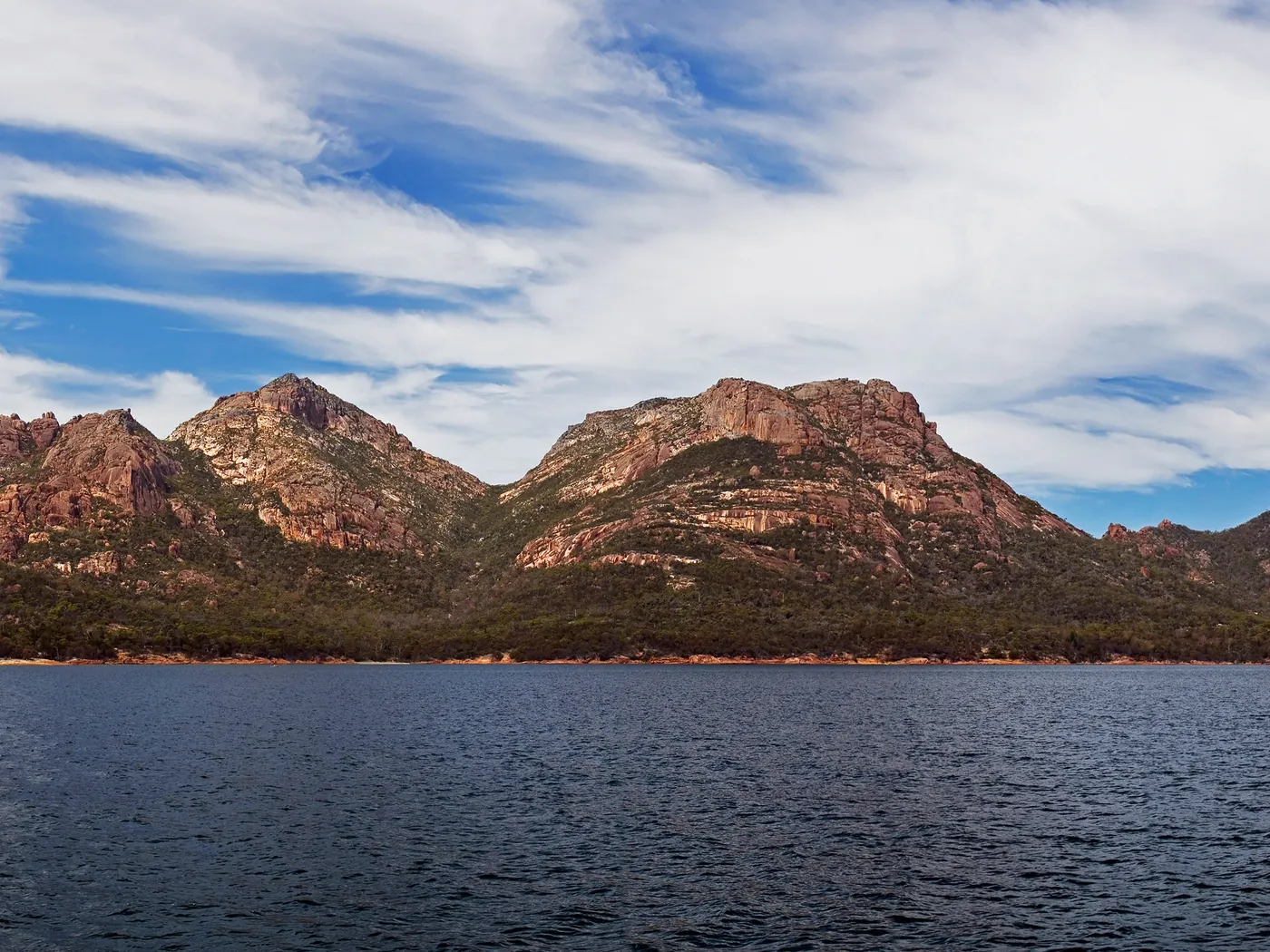 The pink granite peaks of the Hazards above the water at Freycinet