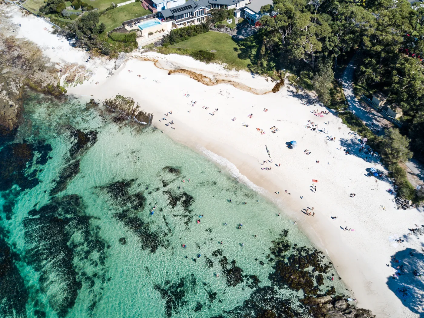 Hyams Beach and the houses behind it, seen from the air