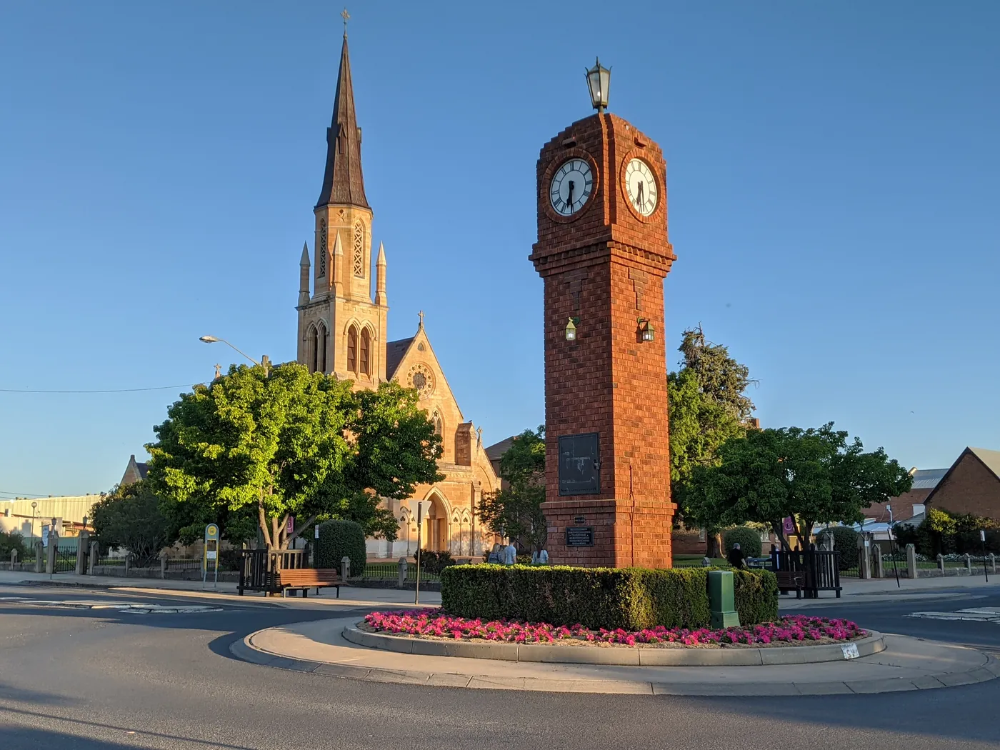 The clock tower and a church spire at the roundabout in central Mudgee