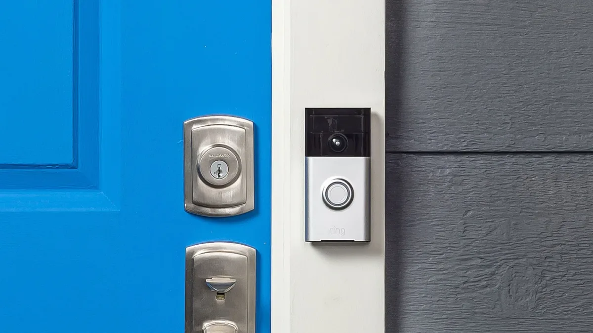 A Ring video doorbell mounted beside a blue front door