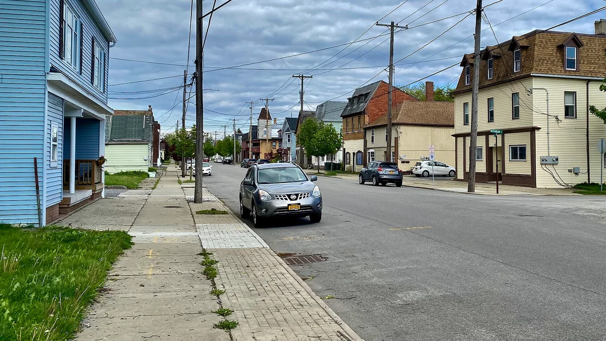 A quiet residential street lined with houses and trees in Depew, New York