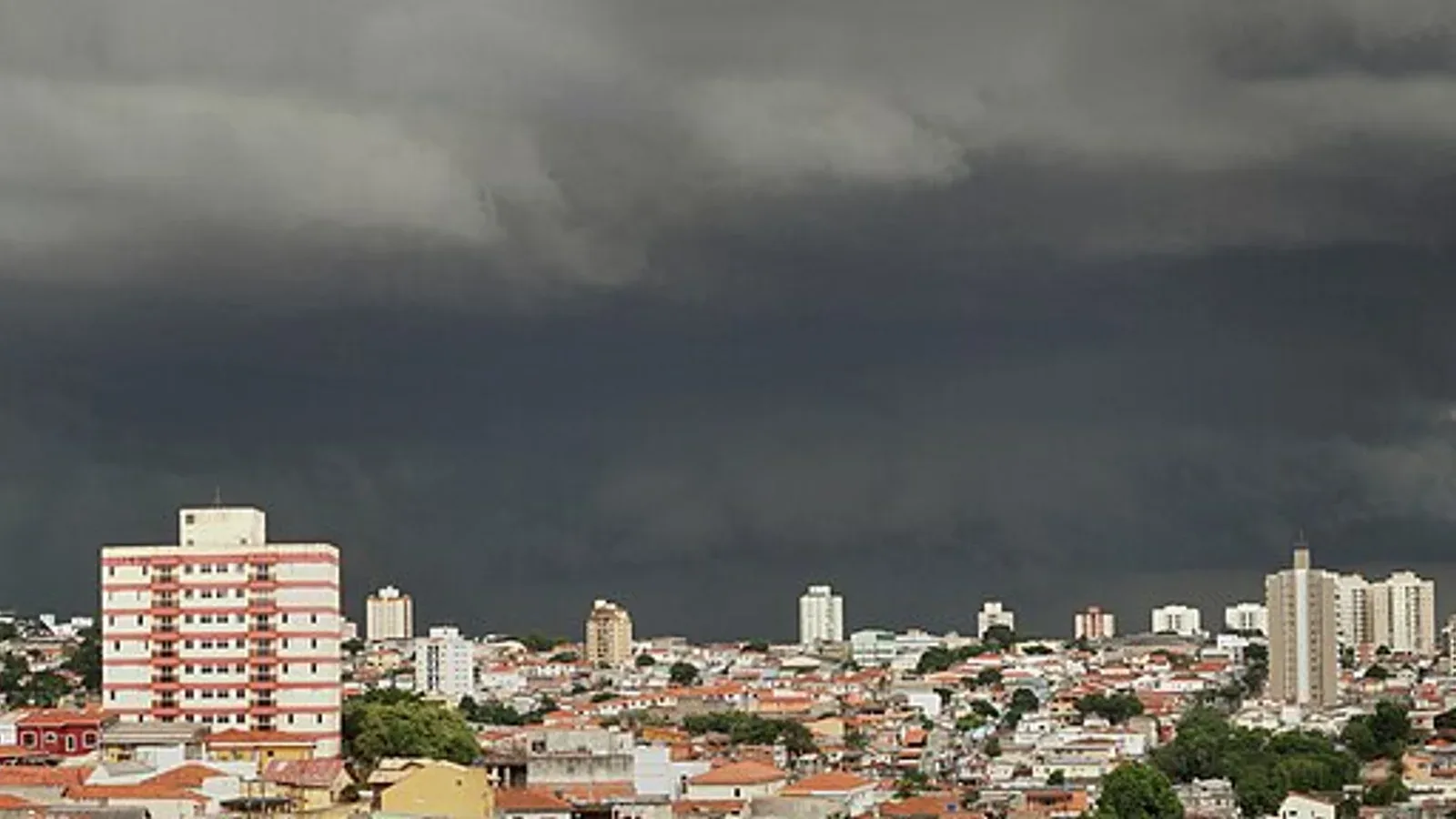 A large summer thunderstorm over a city skyline
