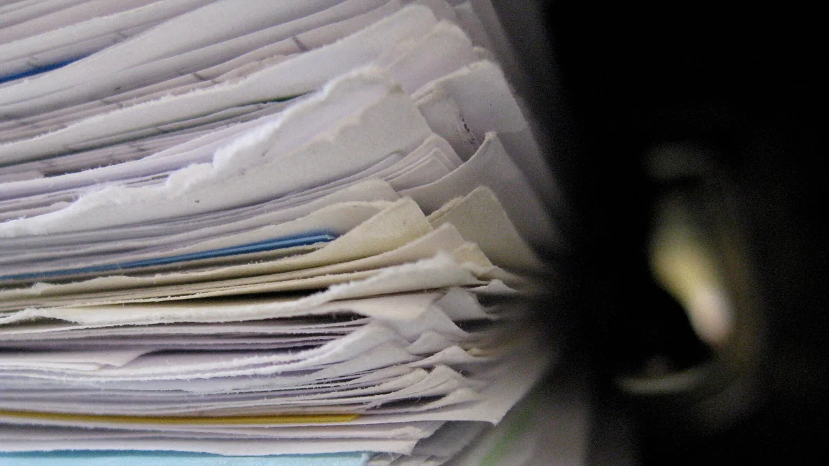 A thick stack of paper files