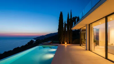 Named luxury villa glowing at dusk above the sea, the standard for an Airbnb Luxe marketing presentation