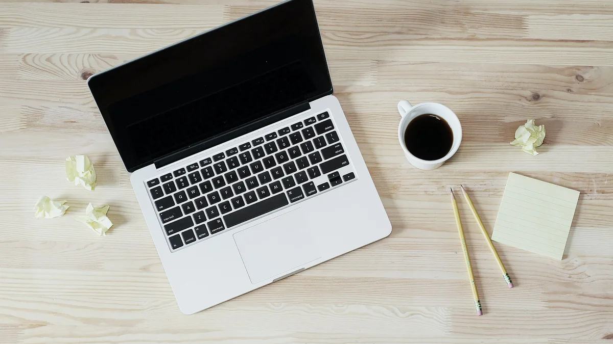 A laptop and coffee on a desk