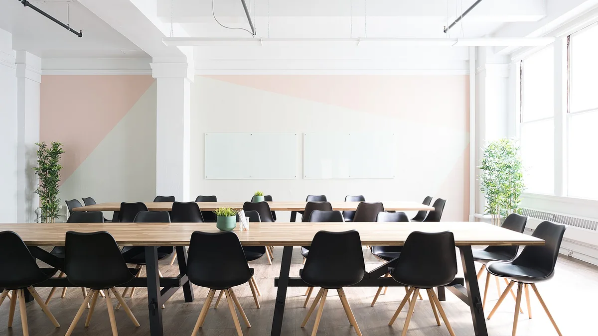 An empty meeting room with a long table and chairs