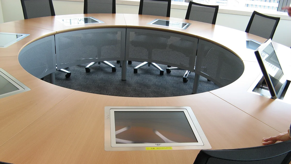 A group of people working together around a large office table