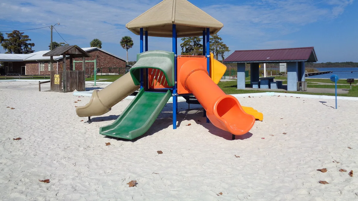 Colorful playground slides at a park, the kind of nearby amenity parents measure in walking minutes