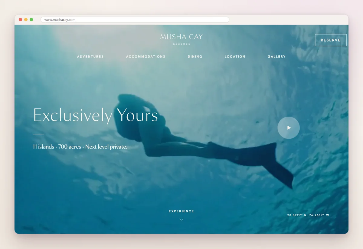 Musha Cay home page with an underwater photo of a swimmer, the line Exclusively Yours, 11 islands and 700 acres, and a Reserve button