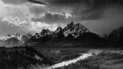 Ansel Adams's black-and-white photograph The Tetons and the Snake River, with the river curving toward the jagged Teton range under dramatic storm light