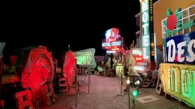 Neon signs lining a path at the Neon Museum in Las Vegas at dusk