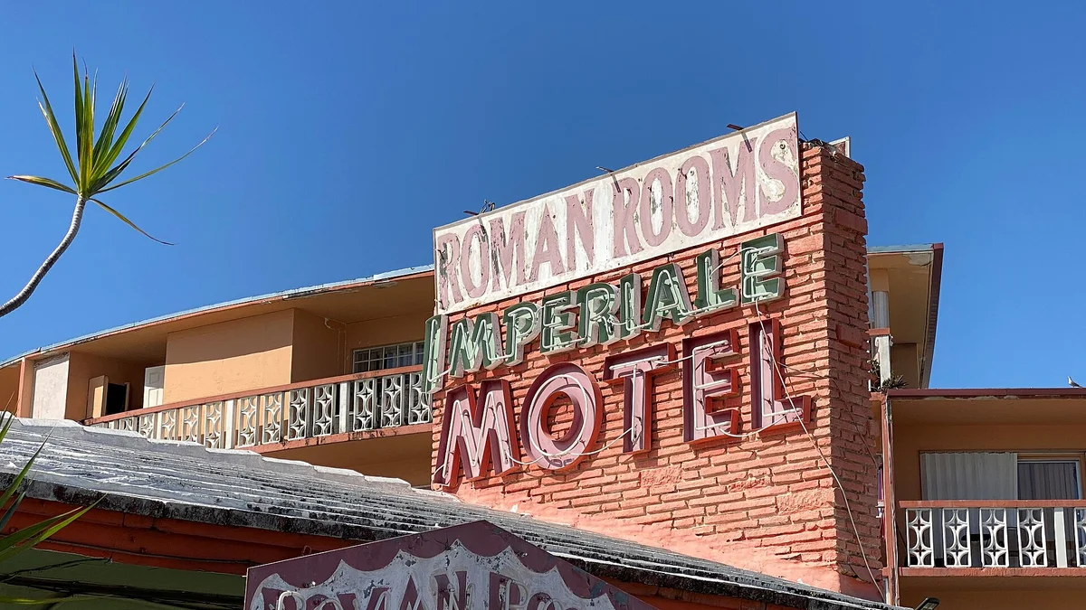 Vintage neon motel sign in Miami for the Roman Rooms Imperiale Motel