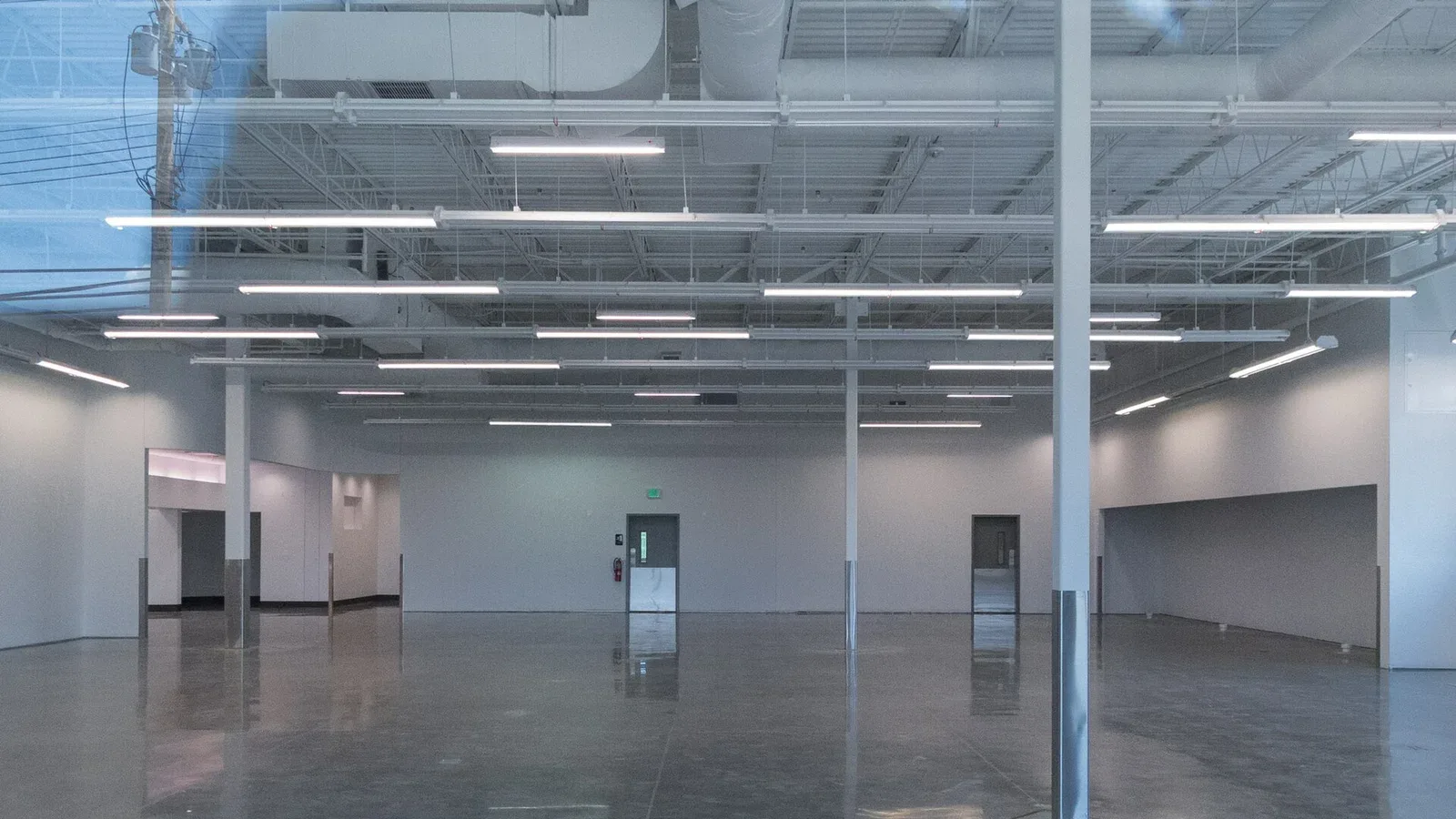 An empty retail interior with bare floors and no fittings