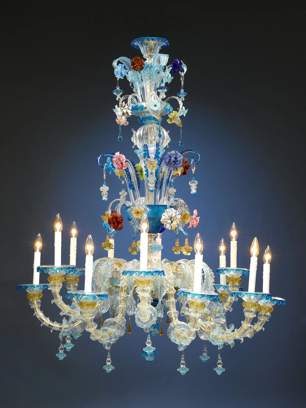 A Murano glass chandelier with candle arms, clear glass leaves and small blue and colored glass flowers