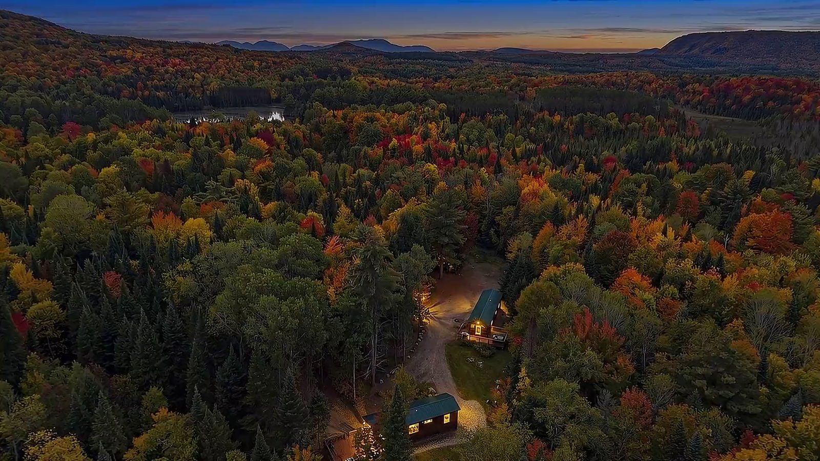 Adirondack Mountain Bungalows — log cabins among autumn trees at dusk in the northern Adirondacks, New York