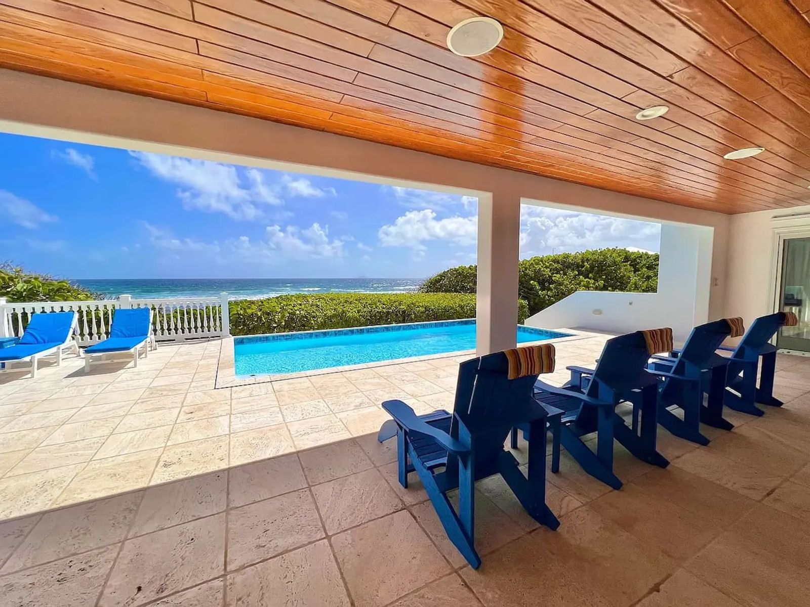Toes in the Sand Beach House — the covered patio and pool facing the sea