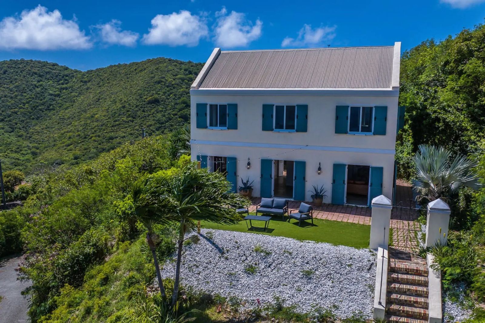 Moko Vista — the two-story hilltop house with blue shutters