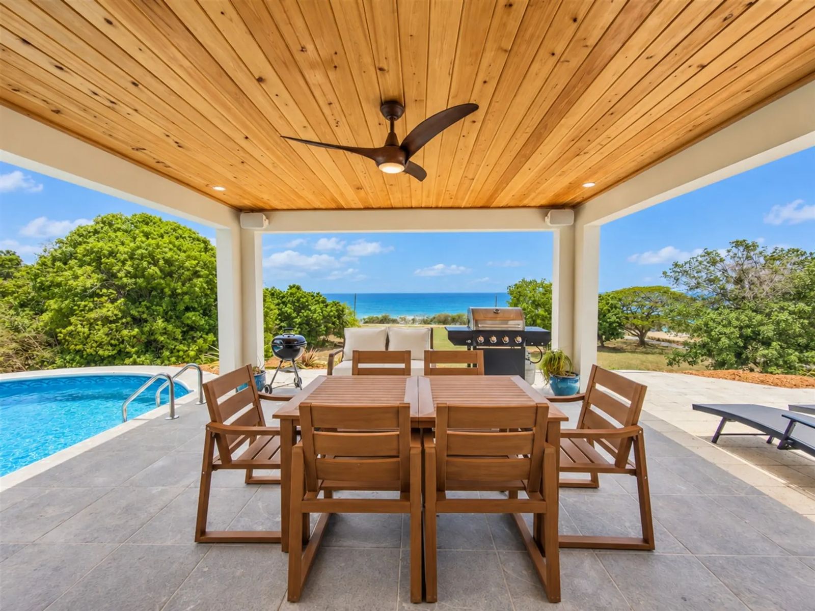 Sunset Sea-Clusion — the covered dining terrace beside the pool