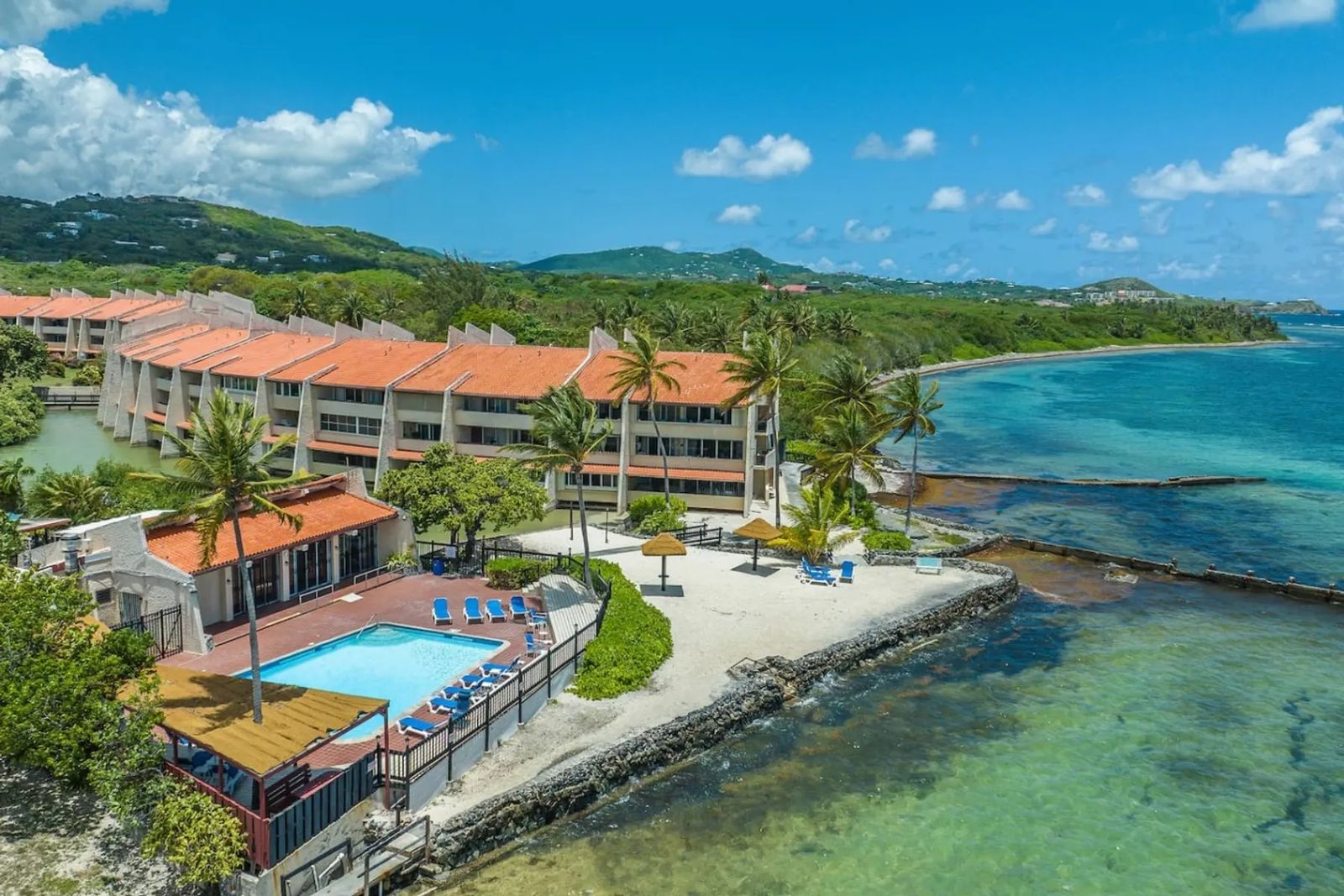 Beach-Access Condo — the waterfront complex and its pool from the air