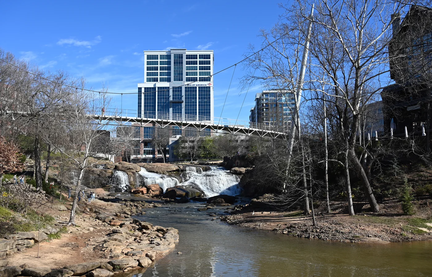 The curved Liberty Bridge over the Reedy River falls at Falls Park in downtown Greenville, South Carolina