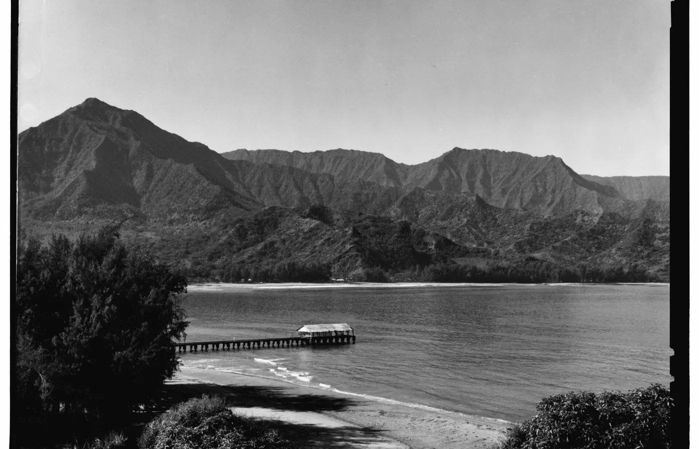 The Hanalei Pier reaching into Hanalei Bay on Kauai's North Shore, the 1912 landmark featured in South Pacific and listed on the National Register in 1979