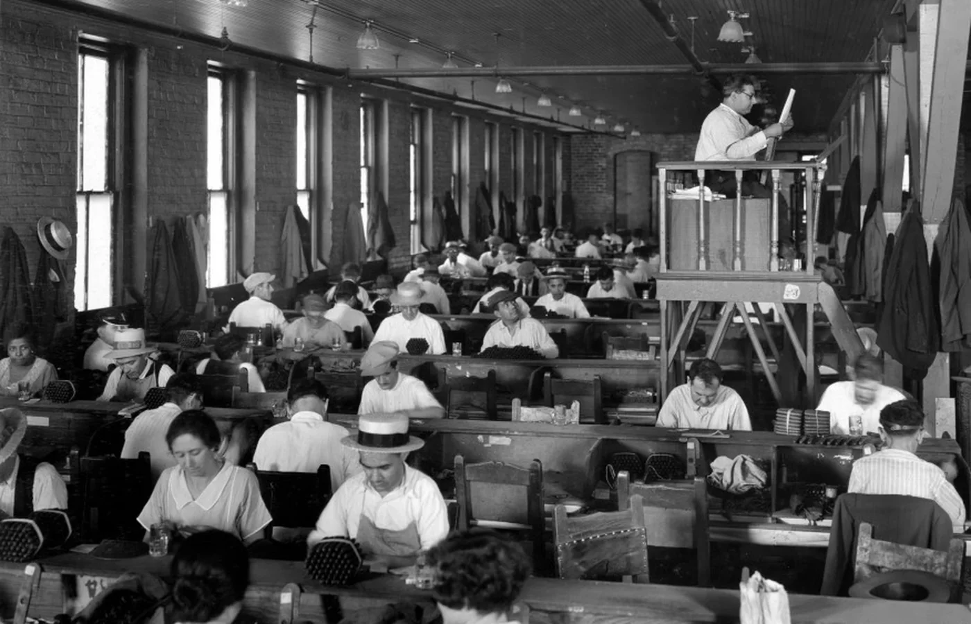 A lector reading aloud to cigar workers from an elevated stand at a Tampa cigar factory in 1929