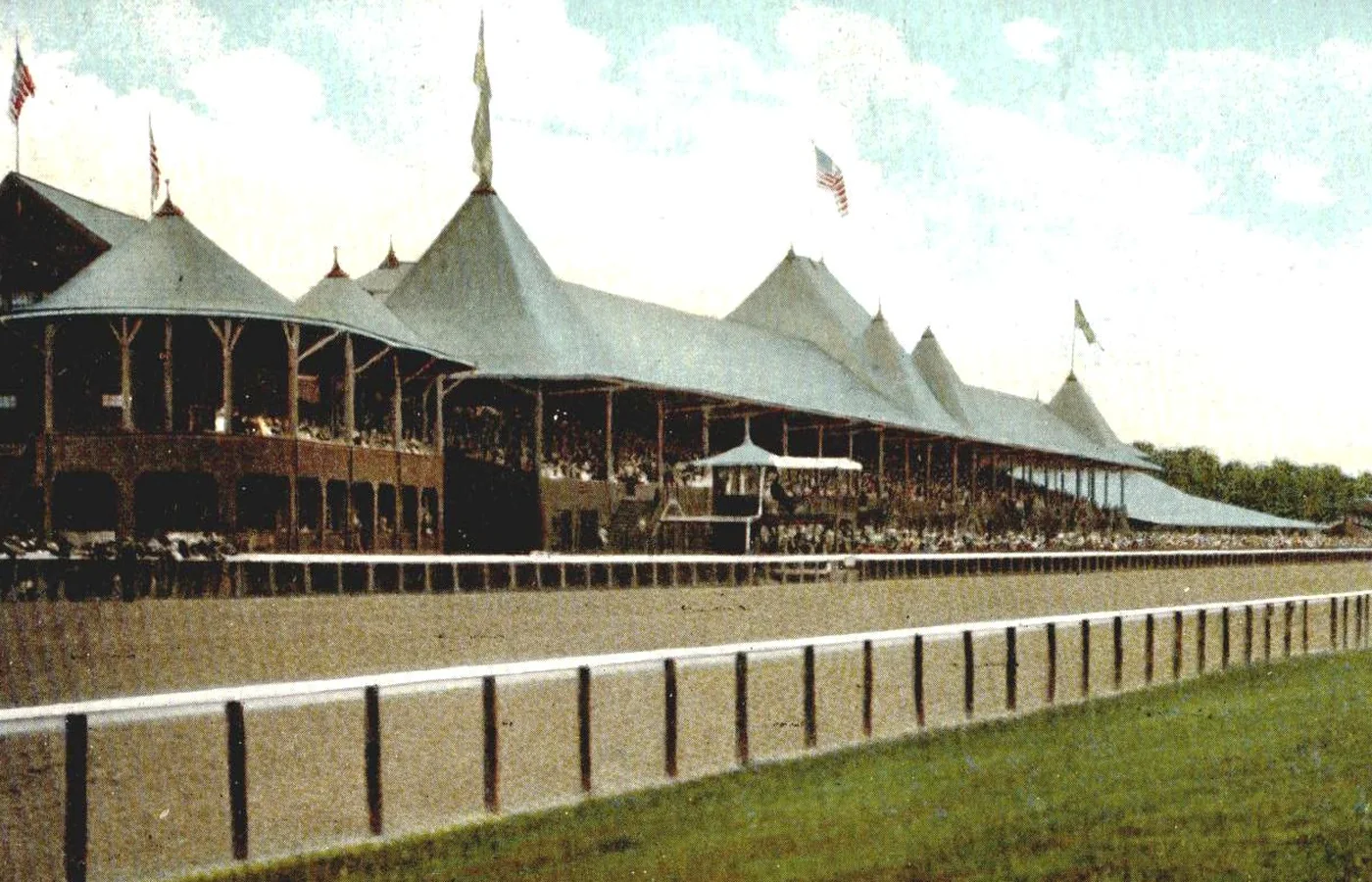 The turreted grandstand of Saratoga Race Course on a 1907 color postcard view