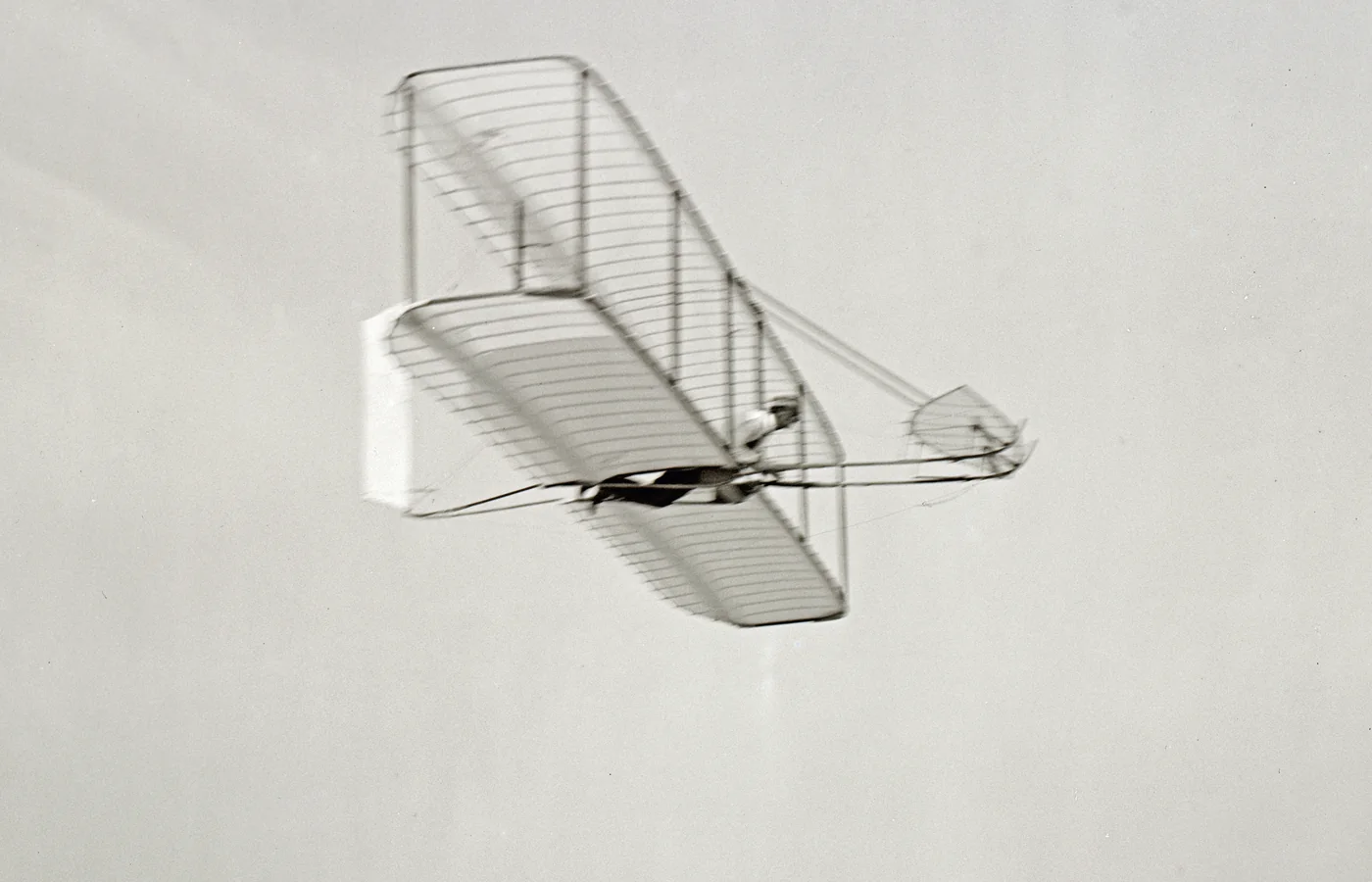 Wilbur Wright gliding over the sand at Kitty Hawk in October 1902