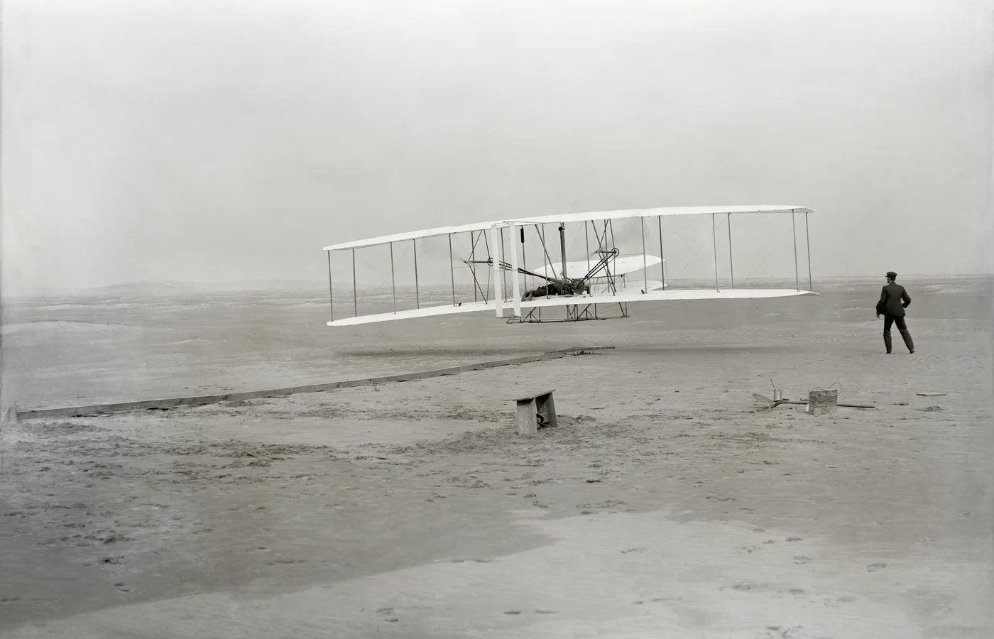 The Wright Flyer lifting off at Kill Devil Hills on December 17, 1903, photographed by surfman John T. Daniels