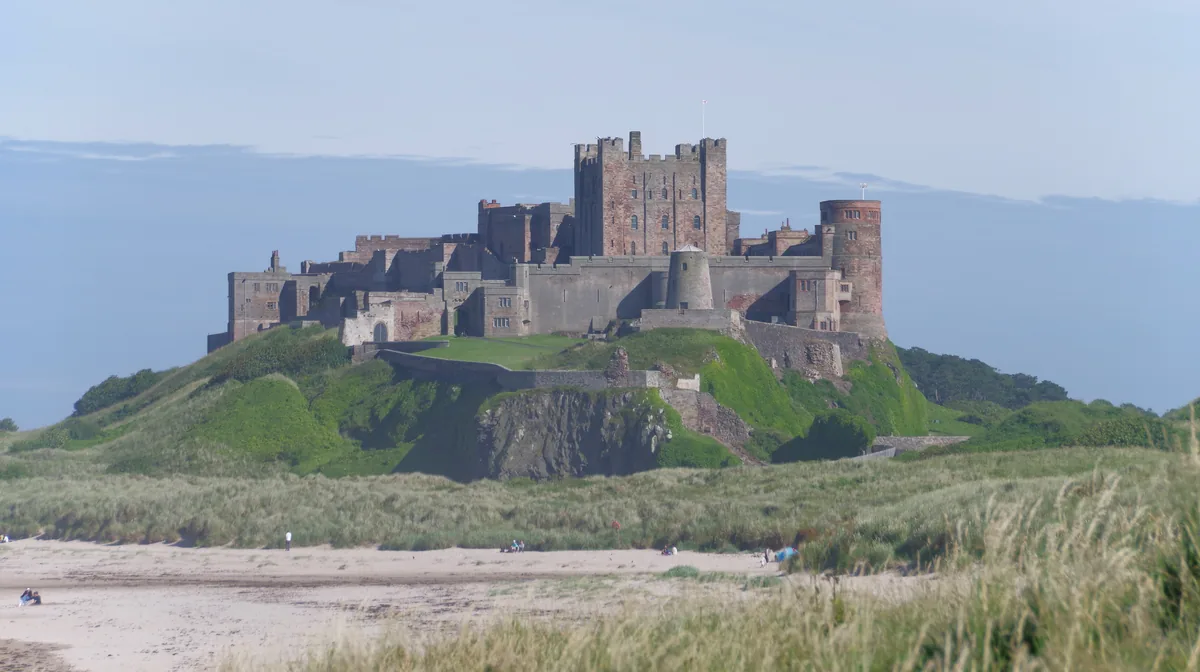 Bamburgh Castle on its crag above the dunes, seen from Bamburgh beach