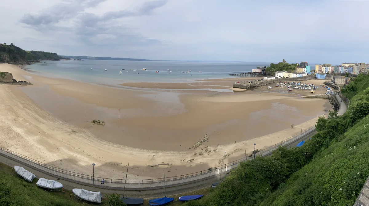 North Beach at Tenby at low tide, with the harbour and the town's coloured houses
