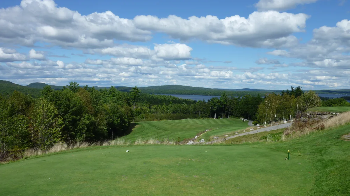 The first hole at Belgrade Lakes Golf Club, with a lake beyond the trees, Belgrade Lakes, Maine