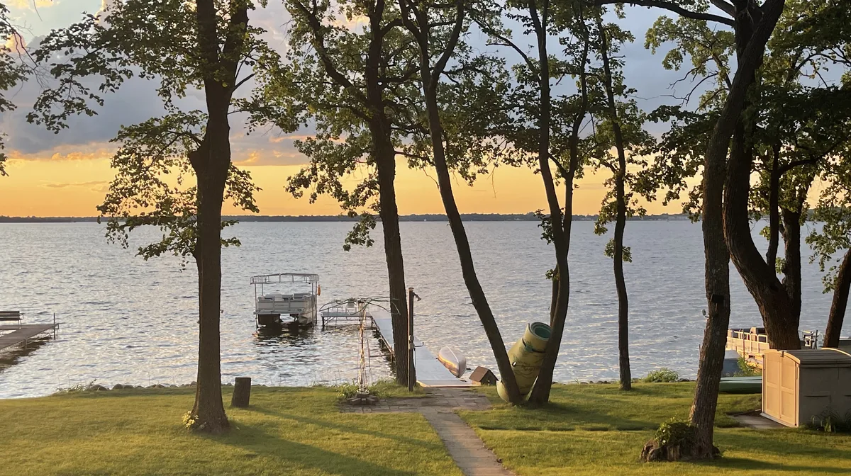 A dock and pontoon boat on the south shore of Detroit Lake at sunset, Detroit Lakes, Minnesota