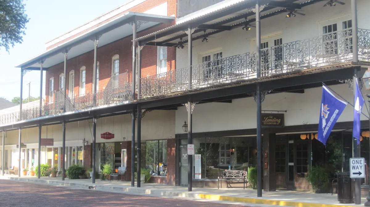 Iron-lace galleries over the brick paving of Front Street in the Natchitoches Historic District, Louisiana