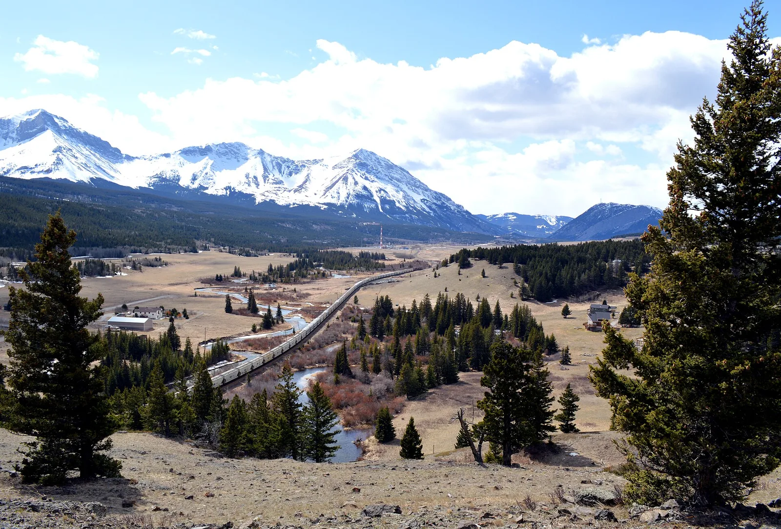 Train heads west into the Crowsnest Pass — Fernie airbnb marketing