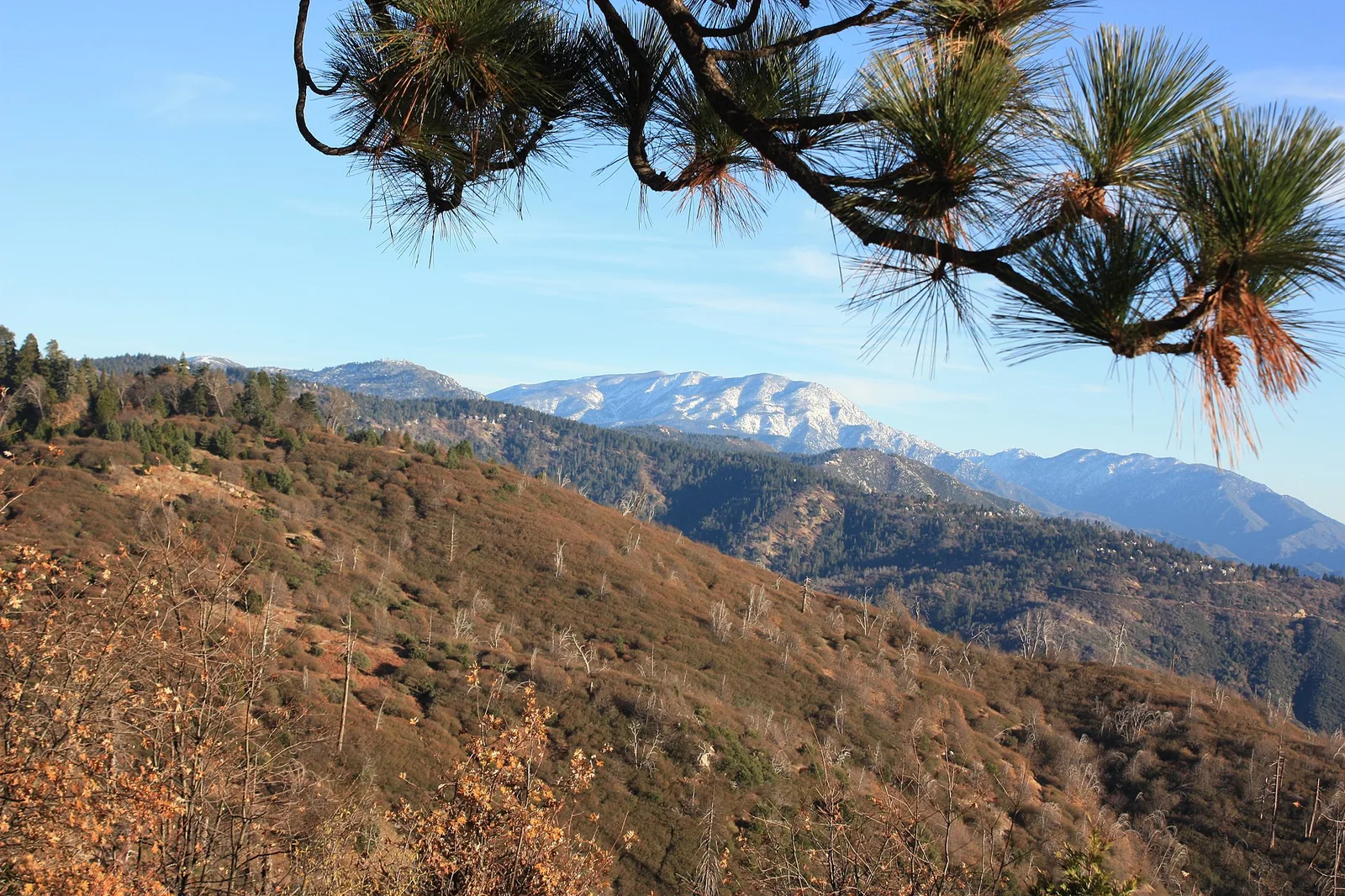 View of snow capped mountains from CA Highway 18 east of Lake Arrowhead turnoff — Lake Arrowhead airbnb marketing