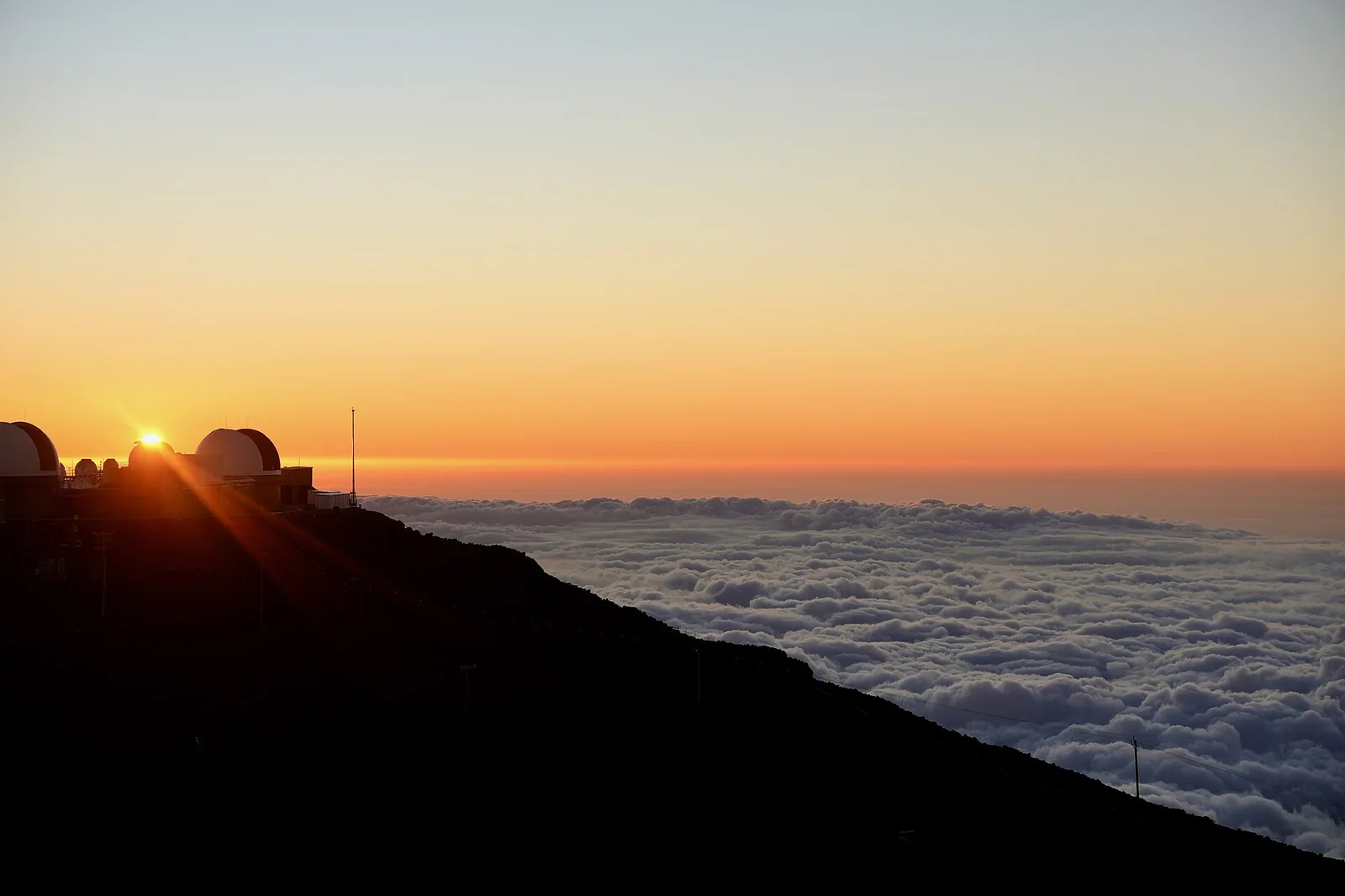 Sunset above the clouds, Haleakala — Maui airbnb marketing