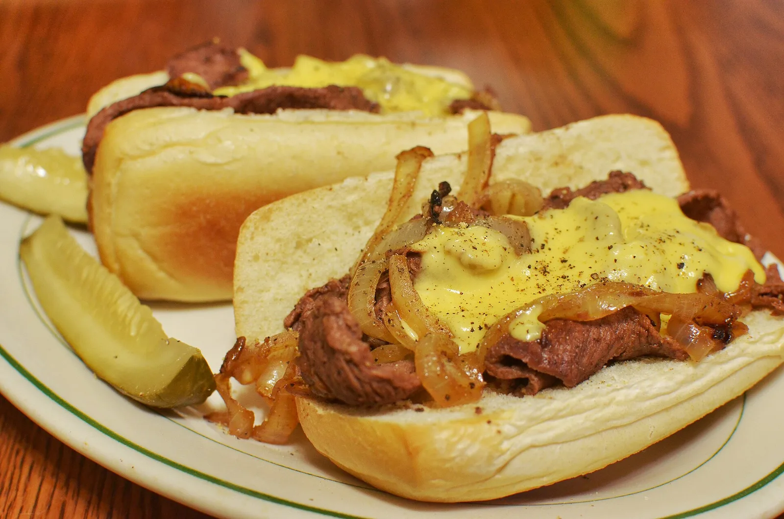 Cheesesteak sandwiches with pickles — Philadelphia airbnb marketing