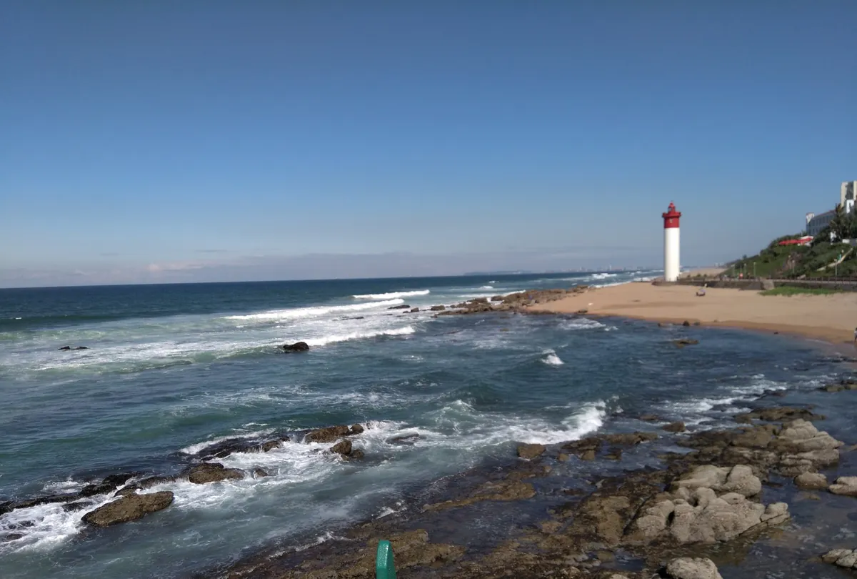 The Umhlanga lighthouse and beach on the KwaZulu-Natal North Coast, seen across the rocks at Umhlanga